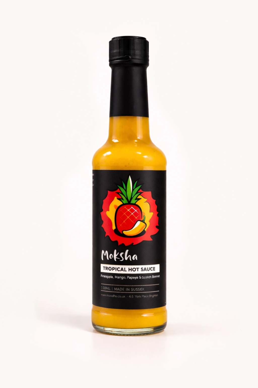 Bottle of Moksha Tropical Hot Sauce with pineapple, mango, papaya and Scotch bonnet